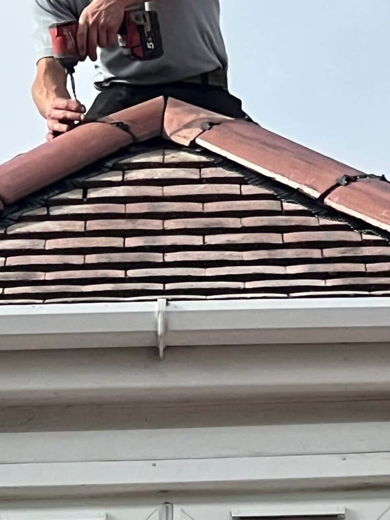 This is a photo of one of the operatives of Beeston Roofing Repairs installing new ridge tiles