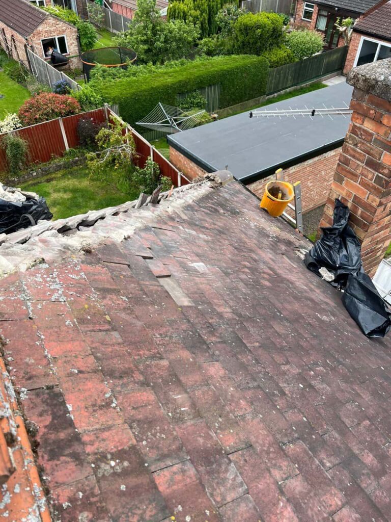 This is a photo of a roof where the hip tiles have been removed, and are just about to be replaced. Works carried out by Beeston Roofing Repairs